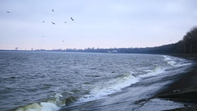 Storm on the Dnieper river in summer, cloudy sky, waves breaking on a rocky shore. City Svetlovodsk, Kirovograd region.