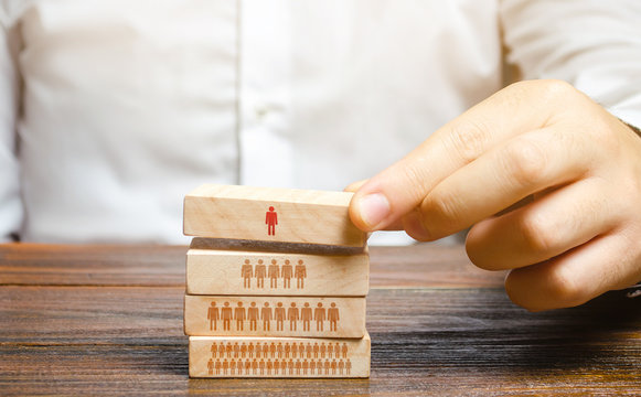 Businessman is building a hierarchy in a company. Leadership, teamwork, feedback in the team. Cooperation, collaboration. Appointment of loyal people to leadership positions. Discipline and order