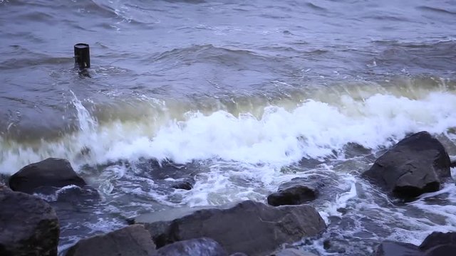 Storm on the Dnieper river in summer, cloudy sky, waves breaking on a rocky shore. City Svetlovodsk, Kirovograd region.