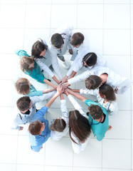 top view. image of a group of doctors joining their palms