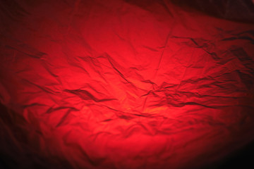 abstract black-and-red texture made of crumpled polyethylene