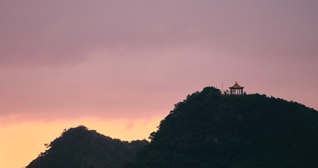 sunset in the mountains with temple on top