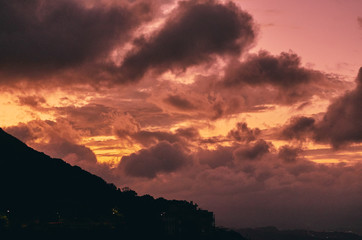 Golden Sun Set in Mountains with Stormy Clouds