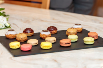 Selective focus shot of small desserts on a black tray