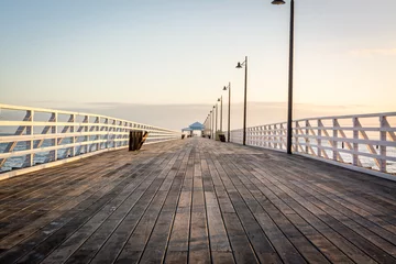 Selbstklebende Fototapeten wooden pier at sunset  © Bradley