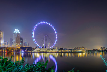 Fototapeta na wymiar Singapore Flyer - Aug 2019 - Light up on Singapore Flyer view look from the marina at blue hour