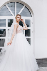 Wedding fashion blondie caucasian girl in beautiful dress outdoors in old city background. Beauty, wedding, fashion concept