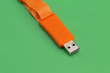 USB memory stick - Orange flash drive on a green background