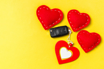 Top view of car key, wooden and textile hearts on colorful background. Saint Valentine's Day concept with copy space