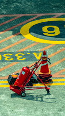 fire extinguisher and traffic cone in the runway.