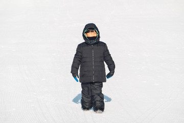 Fototapeta na wymiar An Asian boy is playing snow in winter.