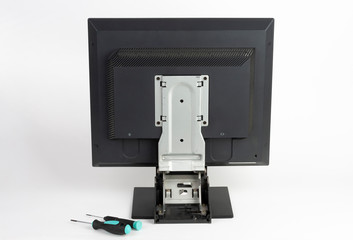 PC Lcd monitor, rear view  and screwdrivers  and plier on white background