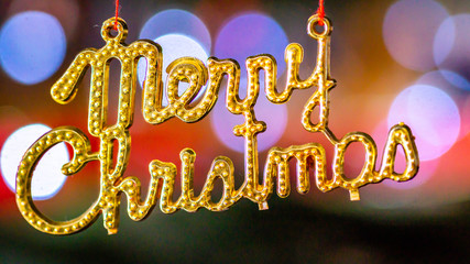 Merry Christmas ornament hang with red needle with blurred background