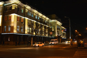 The renovated building of the Dnieper Railway with LED lighting located in the city center, along Dmitry Yavornitsky Avenue at night.