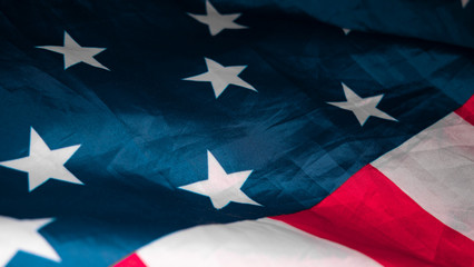 American flag. Closeup of United States flag. The camera flies over the lying, wavy flag of the United States of America. Background.View from above. The concept of patriotism and freedom.
