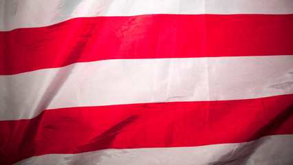 American flag. Closeup of United States flag. The camera flies over the lying, wavy flag of the United States of America. Background.View from above. The concept of patriotism and freedom.