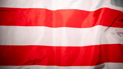 American flag. Closeup of United States flag. The camera flies over the lying, wavy flag of the United States of America. Background.View from above. The concept of patriotism and freedom.