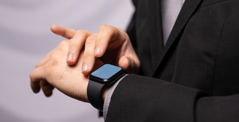 Obraz premium Close up of Businessman's hand looking at hand watch
