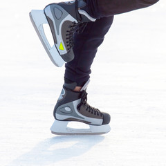 close-up legs of a man skates on an ice rink