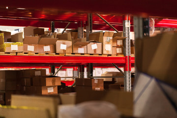 Modern warehouse shelves with pile of cardboard boxes