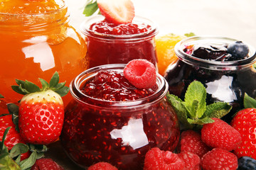 assortment of jams, seasonal berries jelly, mint and fruits and tangerine