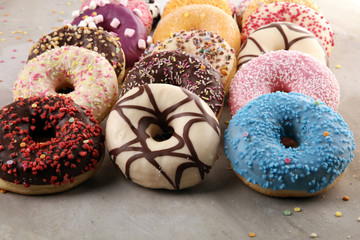 assorted donuts with chocolate frosted, pink glazed and sprinkles donuts