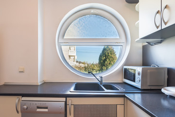 Interior of a kitchen, round window