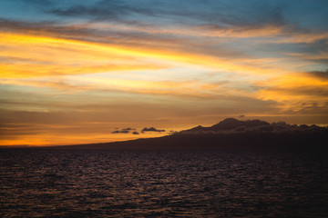 Colorful view of Cebu Philippines coastline with colorful sky, clouds and mountain