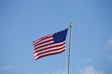 Flag of USA waving against blue sky