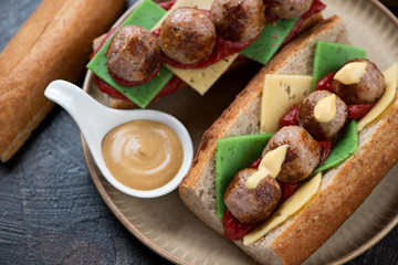 Submarine sandwiches with meatballs and cheese, elevated view, close-up, horizontal shot