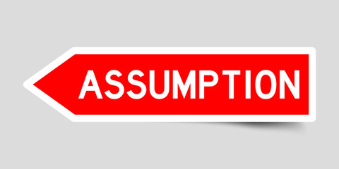 Red color arrow sticker with word assumption on gray background