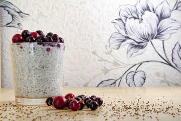 healthy breakfast of chia yogurt seeds and wild berries on a wooden background fitness food. copy space