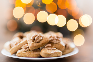 Gingerbread hearts with walnut. Background Abstract blurred light . Christmas concept