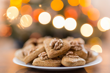 Gingerbread hearts with walnut. Background Abstract blurred light . Christmas concept