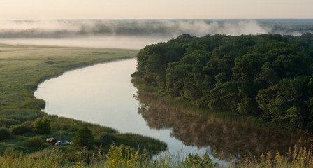 Camping with cars and summer morning fog over the river in the Voronezh region, nature of Russia.