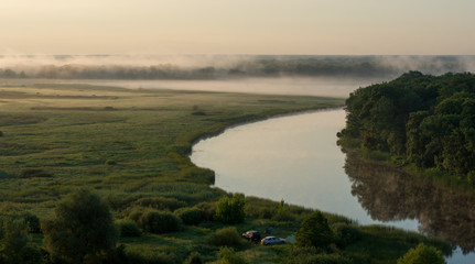 Camping with cars and summer morning fog over the river in the Voronezh region, nature of Russia.