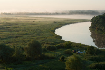 Camping with cars and summer morning fog over the river in the Voronezh region, nature of Russia.