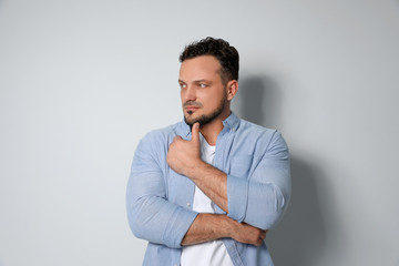 Portrait of handsome man on light grey background