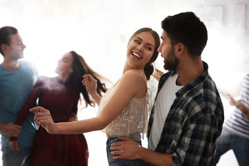 Lovely young couple dancing together at party