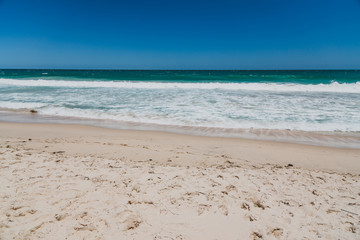 Fototapeta na wymiar view of Scarborough beach, one of the most popular beaches near Perth on the Indian Ocean, with intense turquoise water and ships in the distance