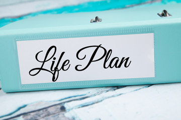Life plan in folder on desk. 