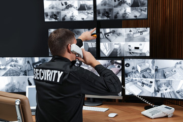 Security guard talking on telephone at workplace