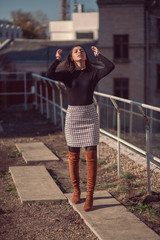 Fototapeta premium Fashion woman portrait of young pretty trendy girl posing at the city in Europe, autumn street fashion.