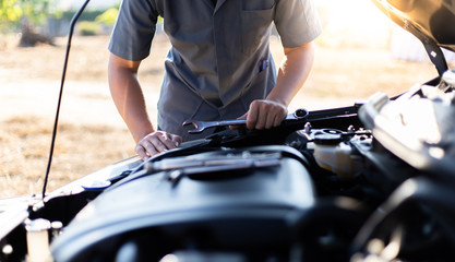 Car mechanic has checked the condition of the engine in wrench, Car repair service concept.
