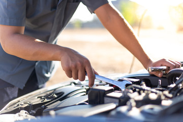 Car mechanic has checked the condition of the engine in wrench, Car repair service concept.