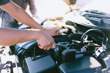 Car mechanic has checked the condition of the engine in wrench, Car repair service concept.