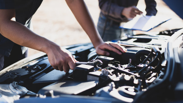 Car mechanic has checked the condition of the engine in wrench, Car repair service concept.