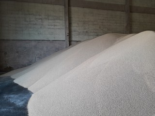 Chemical fertilizer piles in the warehouse are waiting for the delivery of the type of bulk.