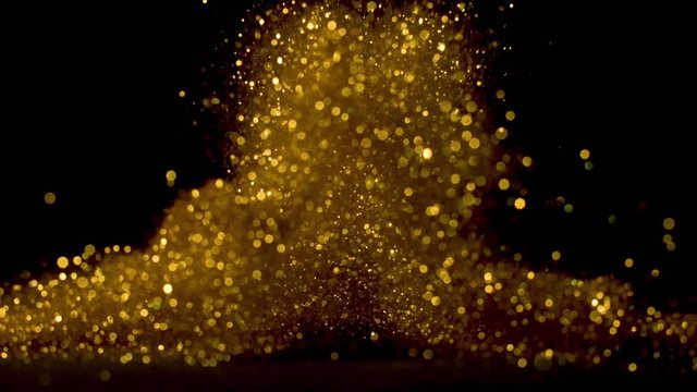 Falling gold glitter particles. Falling shiny confetti with magic, sparkling, bokeh light