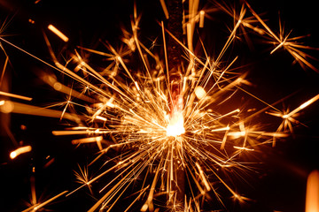 Festive party sparkler on black background 